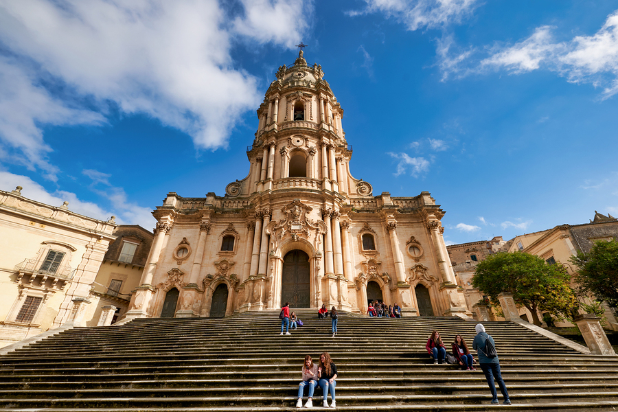 Duomo of San Giorgio stands tall in Modica Sicily under blue sk  Print