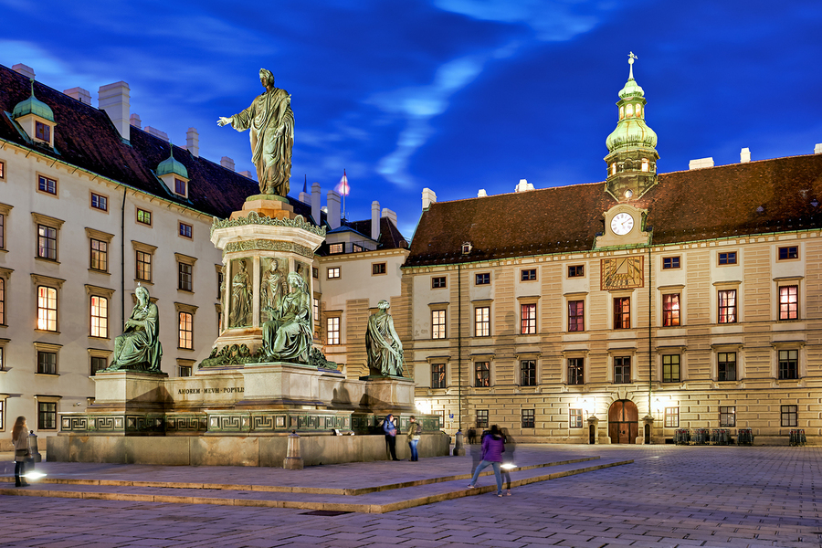 Monument in illuminated Hofburg courtyard Vienna at night.  Print