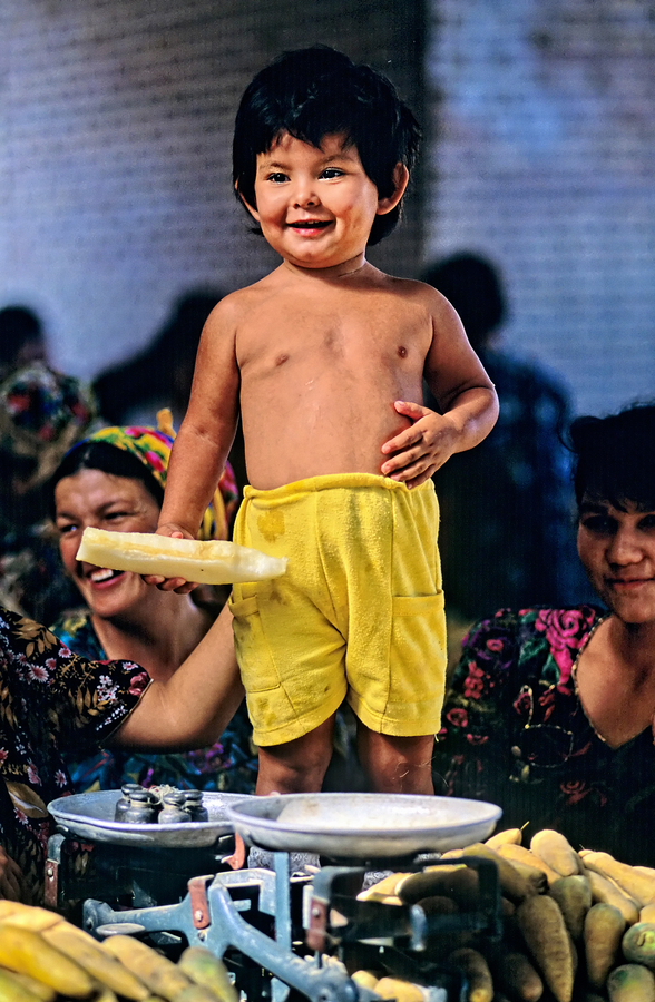 Kid stands at vegetable market in Samarkand Uzbekistan  Print