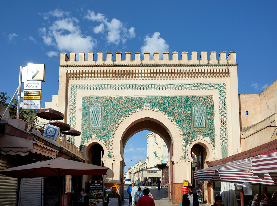 People walk through Bab Bou Jeloud a famous gate in Fez Morocc  Print