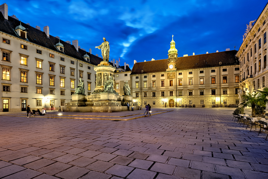 Hofburg Palace square at night with illuminated buildings and st  Print