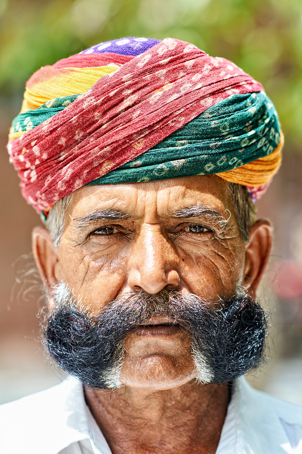 Senior man in colorful turban in Deshnok Rajasthan India  Print