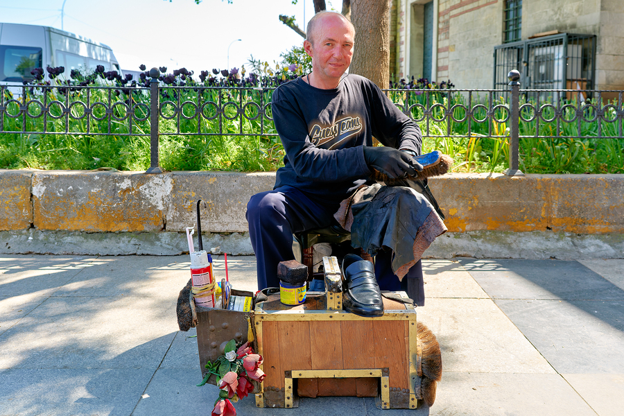 Shoeblack working on shoes in Istanbul Turkey during the day  Print