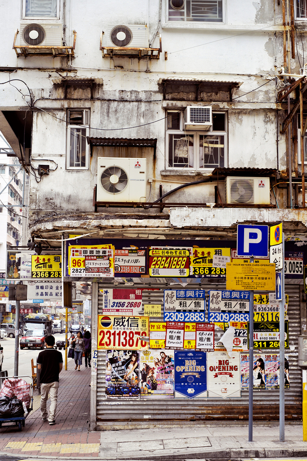 Busy street in Hong Kong shows old building and pedestrians  Print