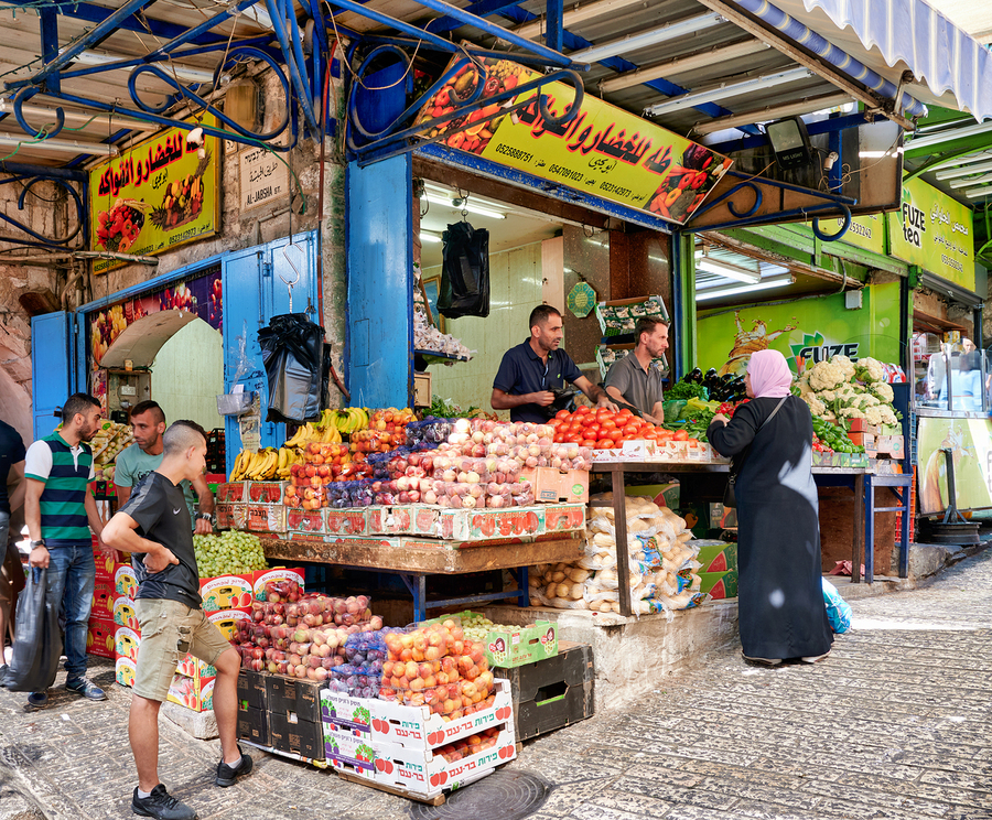 Greengrocer stall in the old city of Jerusalem busy with shopper  Print