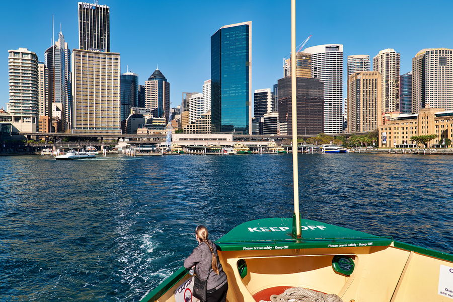Sydney skyline viewed from a ferry on a sunny day.  Print