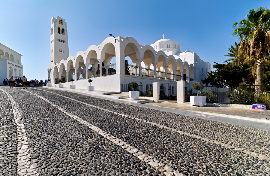 Beautiful white church and cobblestone street in sunny Santorini  Print