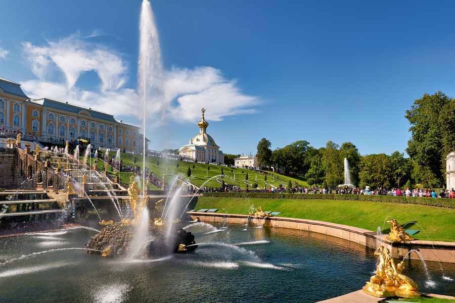 Visitors admire the fountains at Peterhof Palace  Print