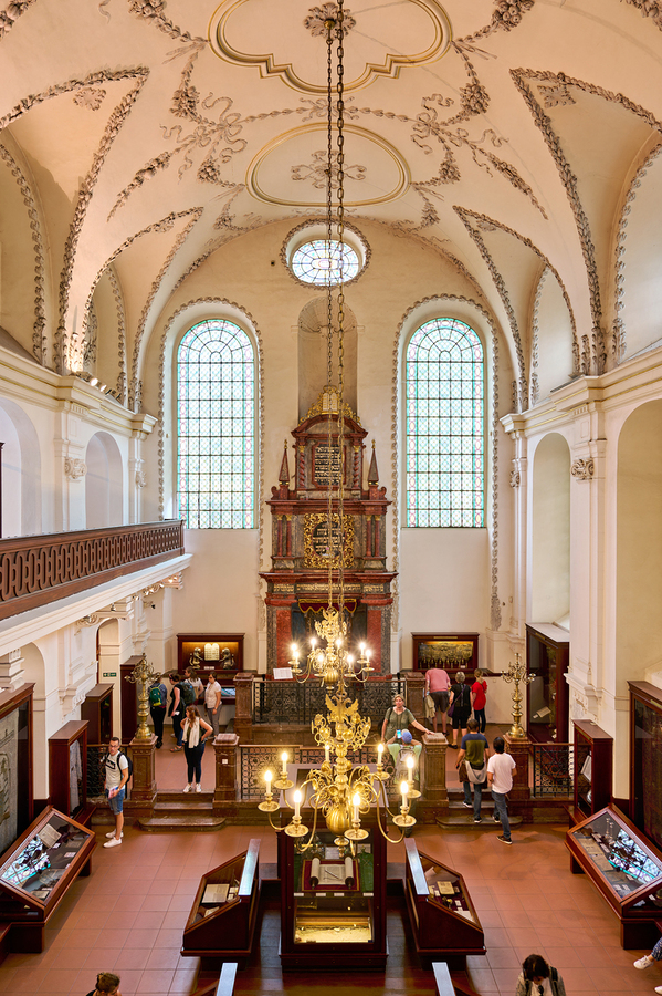 Ornate synagogue interior with tourists chandelier and stained  Print