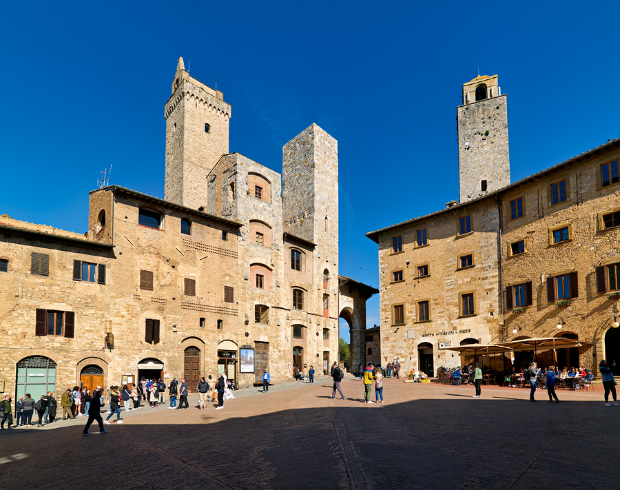 Visitors explore Piazza della Cisterna in San Gimignano  Print