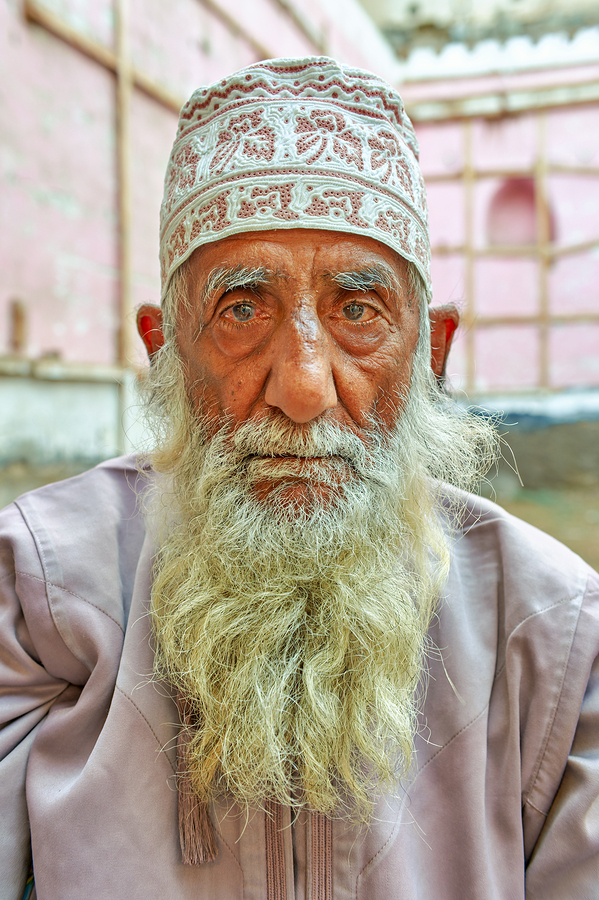 Senior man with white beard in Muscat Oman courtyard  Print