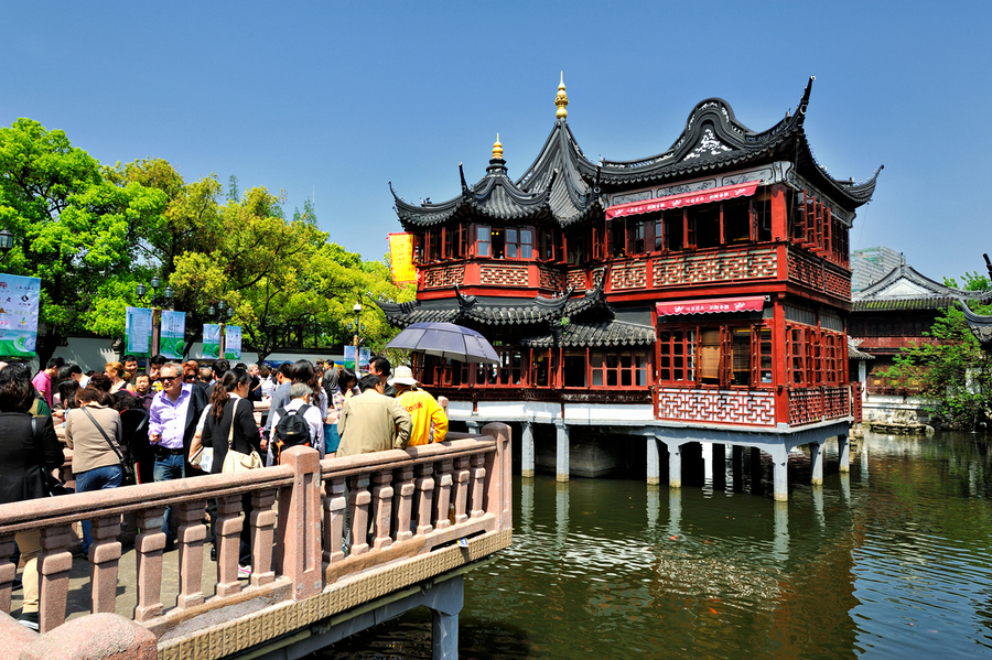 Crowd visits traditional Chinese tea house beside water in Shang  Print