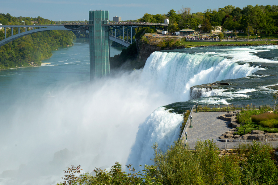 Niagara Falls bridge and observation deck on a sunny day.  Print