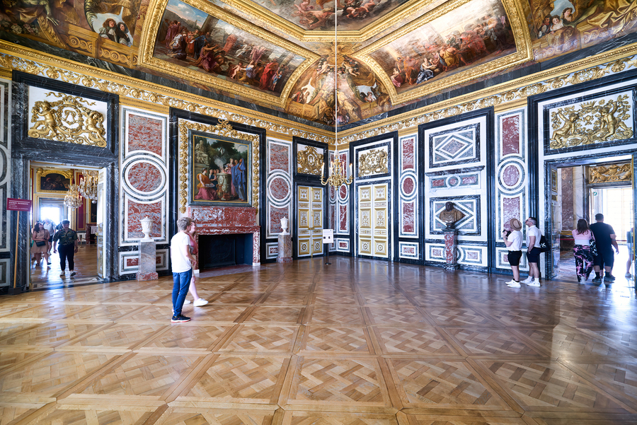 Visitors explore the grand rooms inside the Palace of Versailles  Print