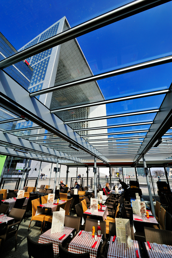 Dining area in Paris with modern building under clear sky  Print