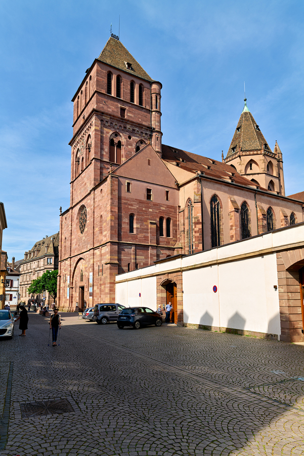Saint Thomas church in Strasbourg with people walking nearby  Print