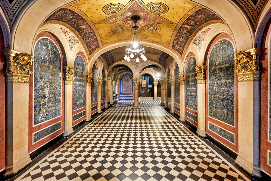 Historic church corridor with ornate arches and checkered floor.  Print
