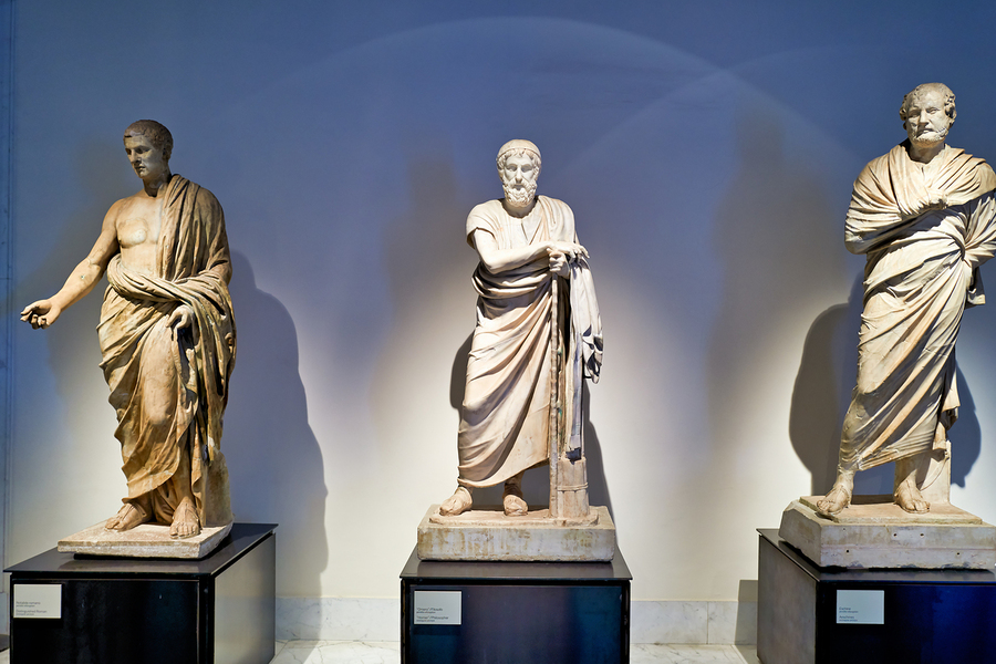 Statues of ancient philosophers displayed in museum setting  Print