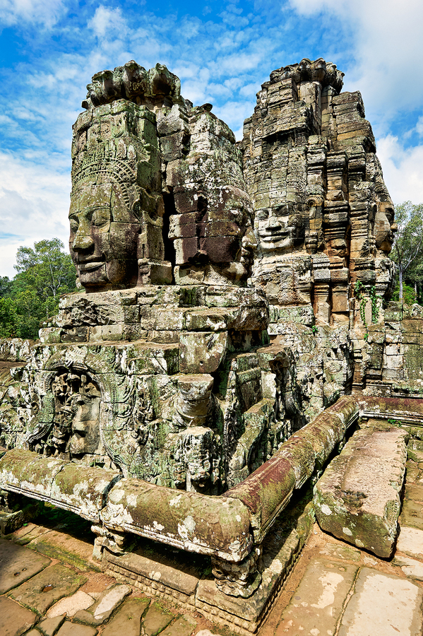 Ancient Khmer temple with carved stone faces.  Print