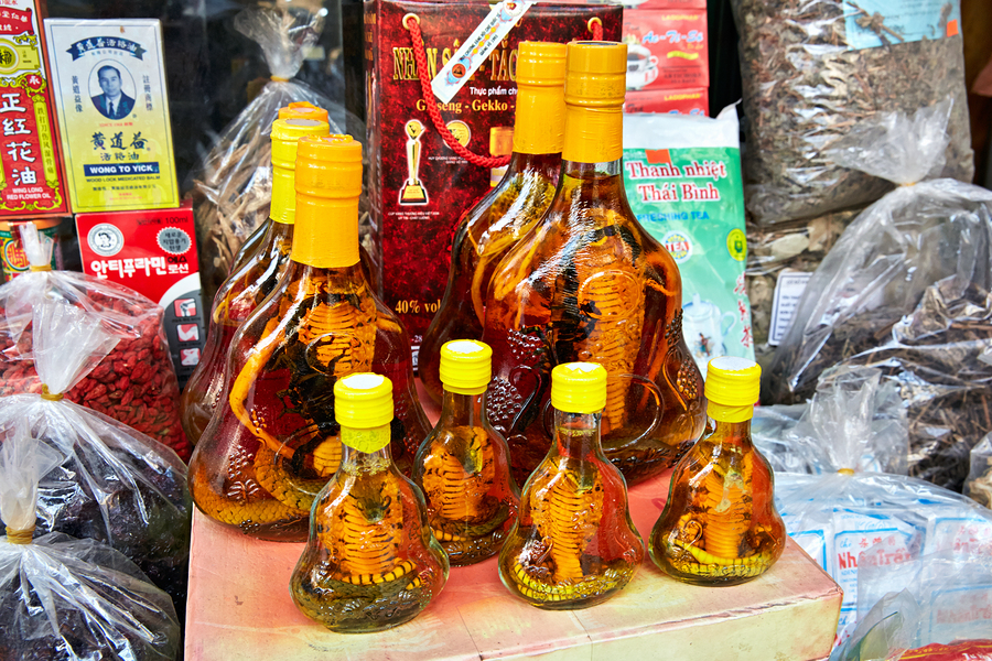 Vietnamese snake wine bottles displayed in Hanoi market  Print
