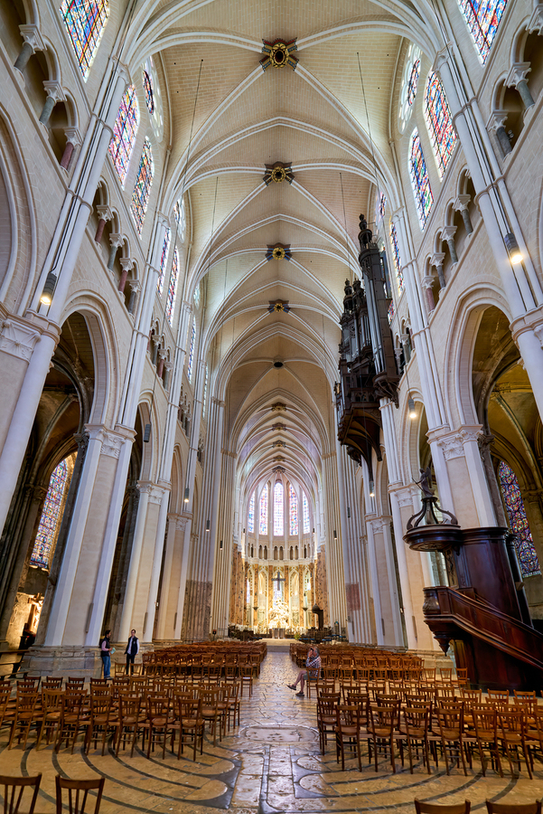 Chartres Cathedral inside with tall arches and wooden chairs  Print