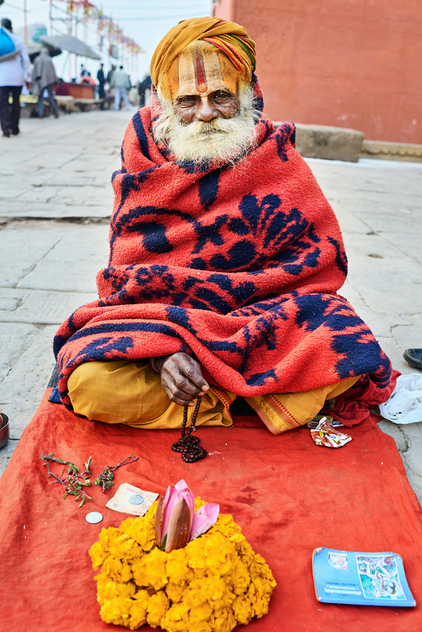 Holy man sadhu sits with offerings in Varanasi Uttar Pradesh  Print