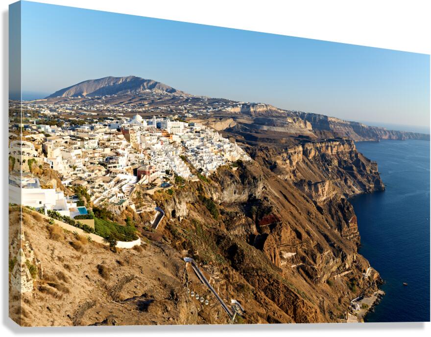 Santorinis white buildings on caldera cliffs above the sea. Canvas Print