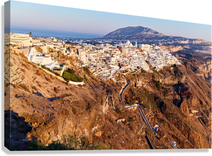 Santorinis Fira town on caldera cliff at sunset. Canvas Print