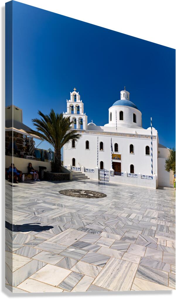 White Greek church with blue dome bell tower and marble courty Canvas Print