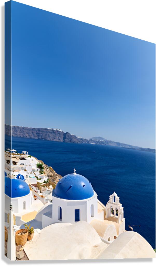 Iconic blue domes and white architecture of Santorini Greece. Canvas Print