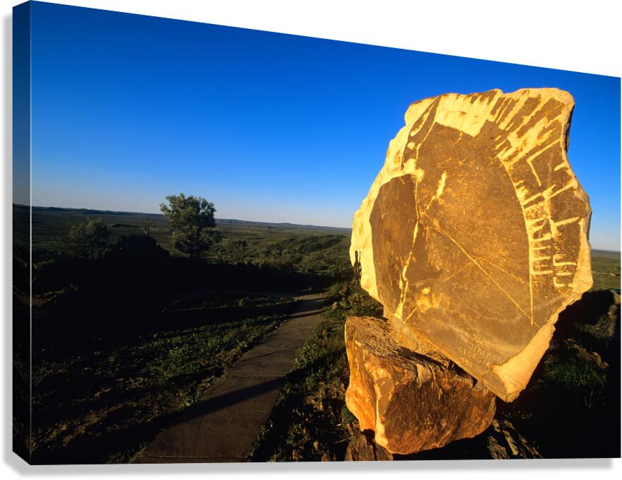 Carved stone monument in the Australian outback at sunset. Canvas Print