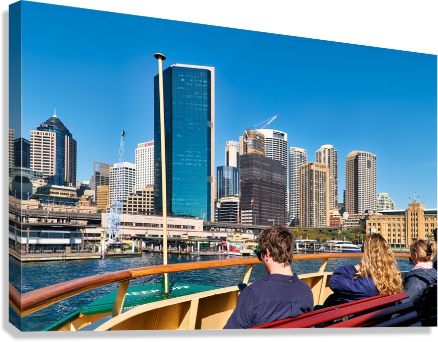 Ferry passengers enjoy city skyline view. Canvas Print