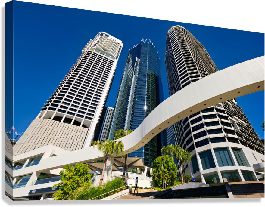 Woman walks on stairs in modern urban area with tall buildings Canvas Print