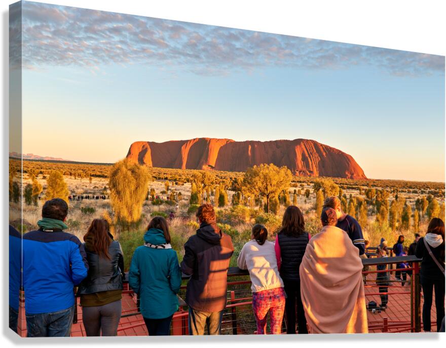 Tourists watch Uluru glow at sunrise. Canvas Print