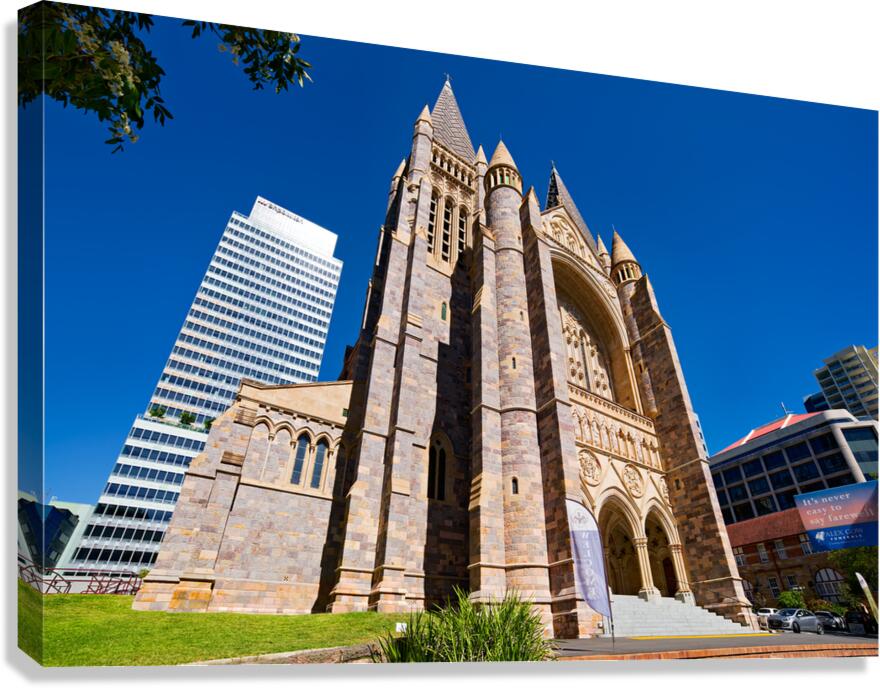 Historic church stands tall next to modern skyscrapers. Canvas Print