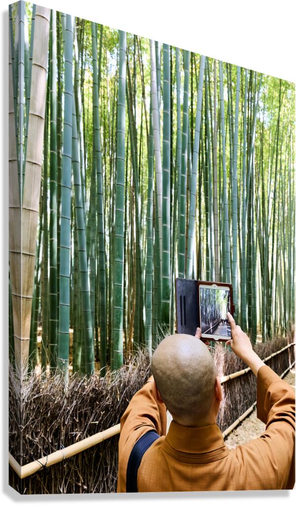 Buddhist monk takes pictures in Arashiyama Bamboo Grove in Japan Canvas Print