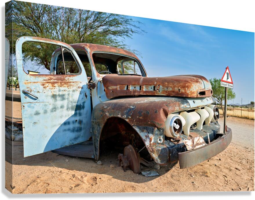 Classic car wreck in Namibias desert environment Canvas Print