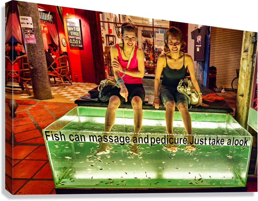 Smiling women enjoy fish foot spa. Canvas Print
