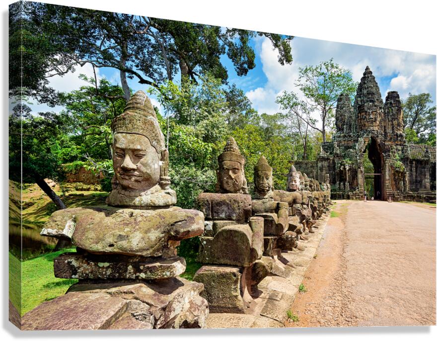 Ancient stone statues line path to Angkor Thom gate. Canvas Print
