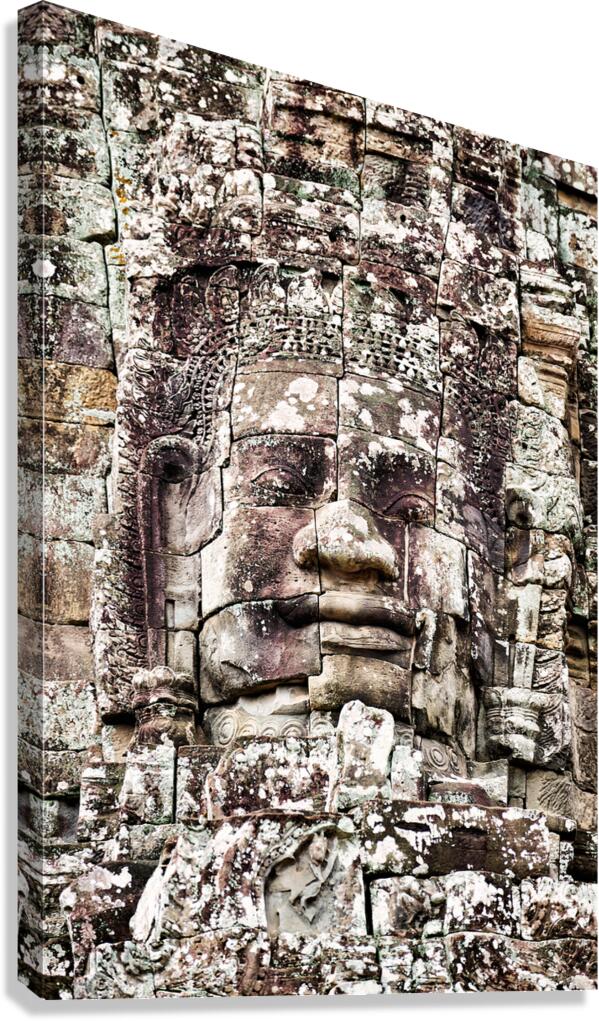 Ancient Khmer stone face Bayon temple. Canvas Print