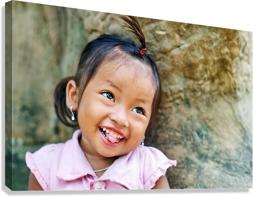 Joyful young girl with a playful smile and tongue out. Canvas Print