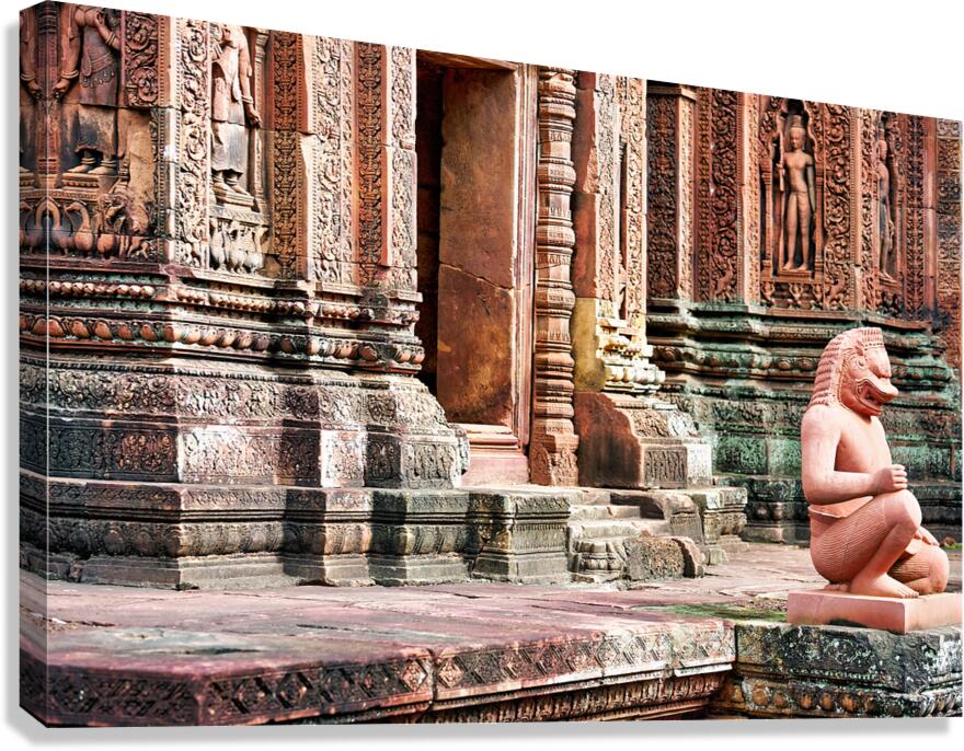 Ancient Cambodian temple with intricate carvings and guardian st Canvas Print
