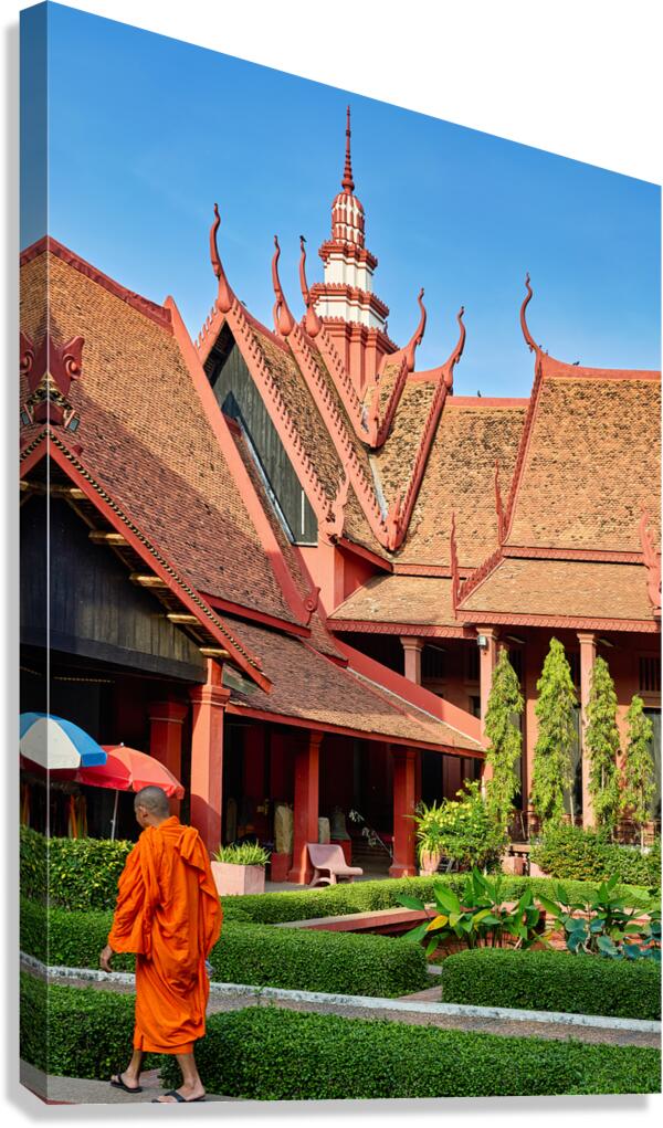 Monk walks through traditional Cambodian temple garden. Canvas Print