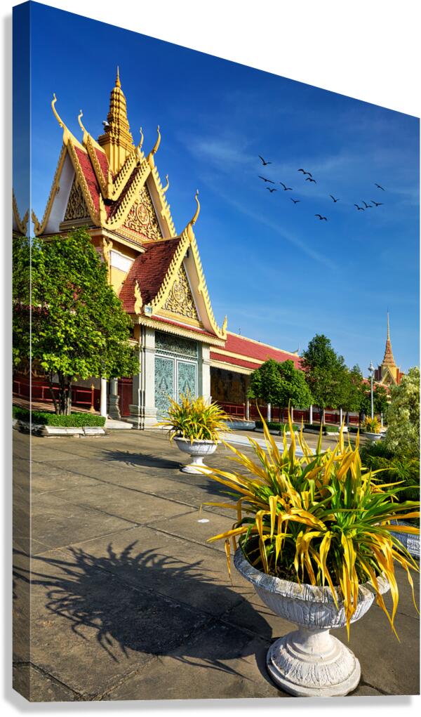 Golden temple green trees and birds under a blue sky. Canvas Print