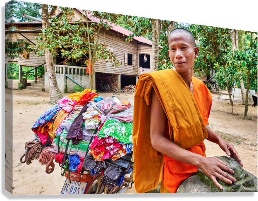 Monk with colorful textiles on a motorcycle. Canvas Print