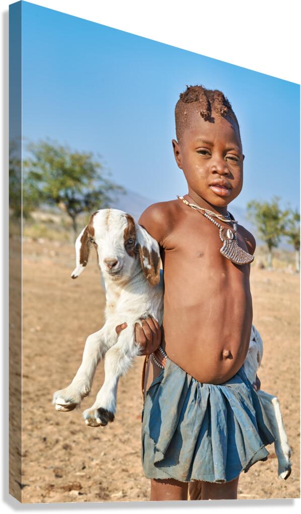 Himba child holding a goat in Kunene Region of Namibia Canvas Print