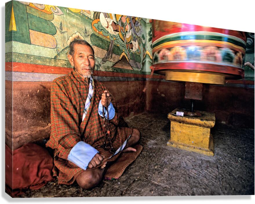 Bhutanese man with prayer beads and spinning prayer wheel. Canvas Print