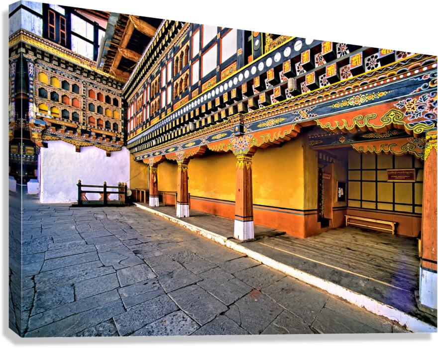 Vibrant ornate Bhutanese temple architecture and stone courtyar Canvas Print