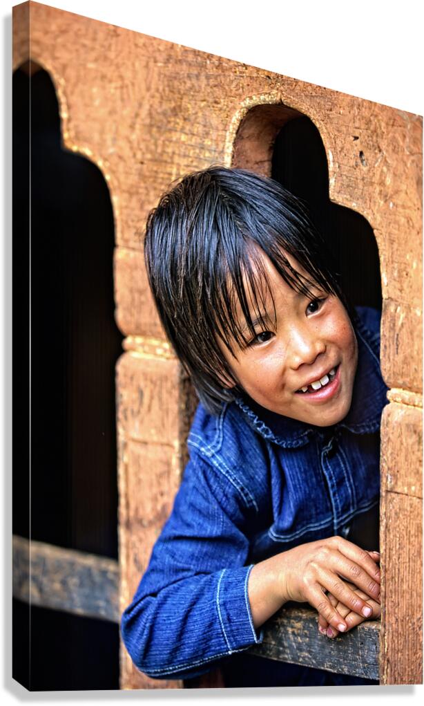 Smiling child peeking from a wooden window. Canvas Print