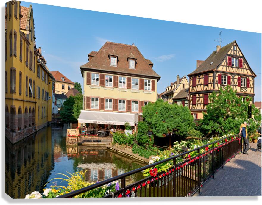 Visitors stroll by timber framed houses along the canal in Colma Canvas Print